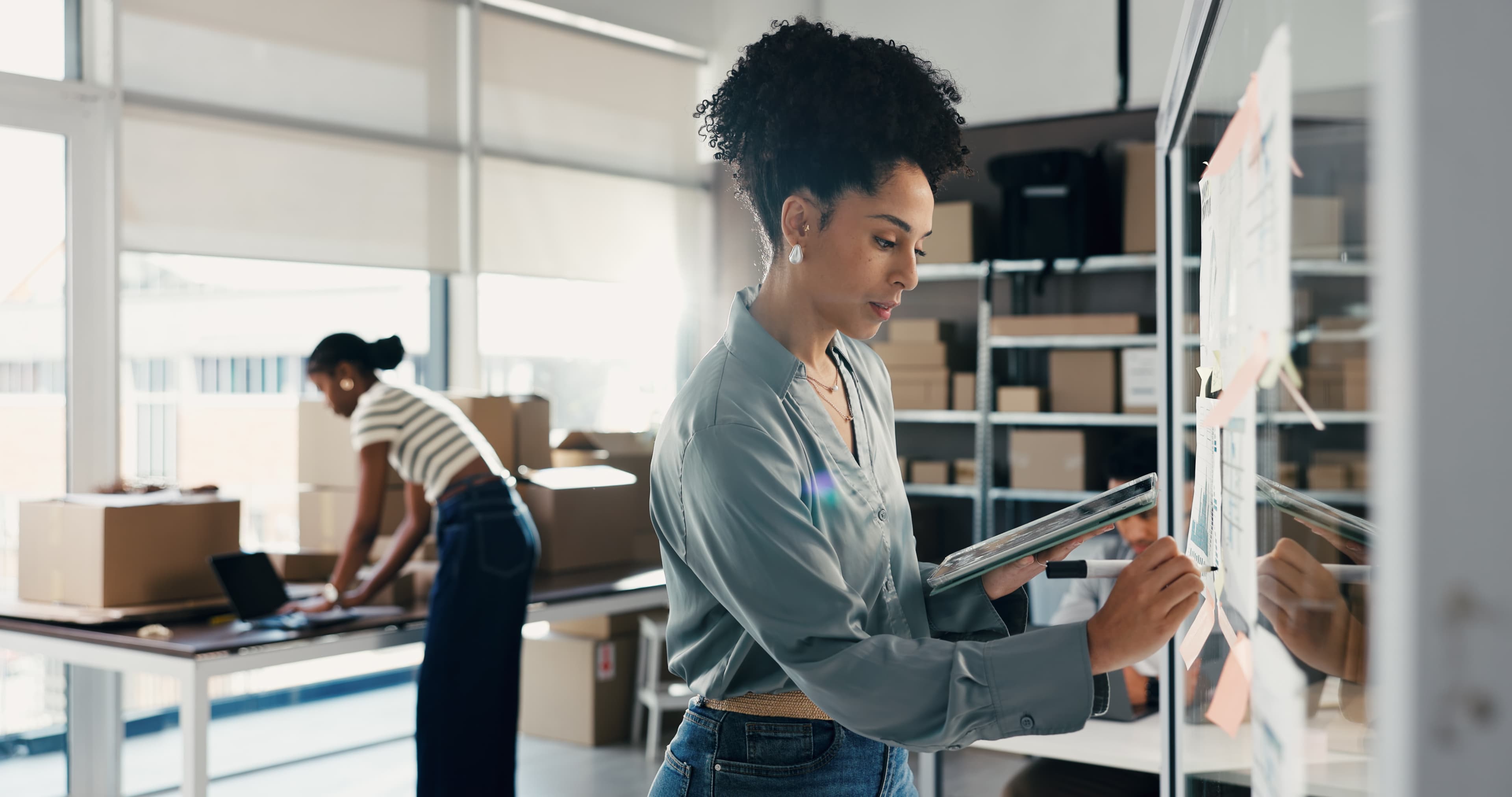 Warehouse workers managing shipping operations at scale with organized packages and logistics workflow